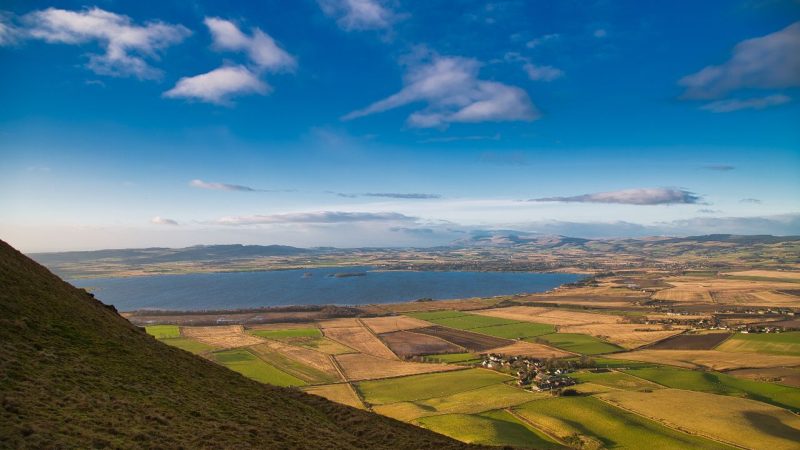 The view towards Loch Leven overlooking fields from a hilltop