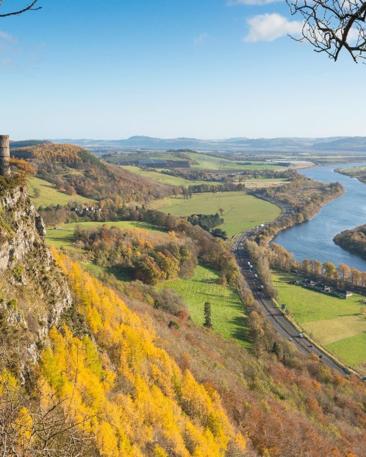 A round stone tower sits at the top of a sheer cliff face