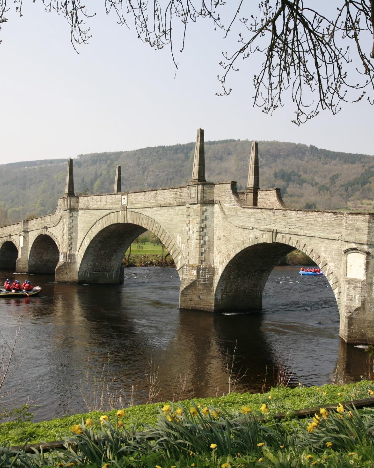 An arching stone bridge spanning over a river