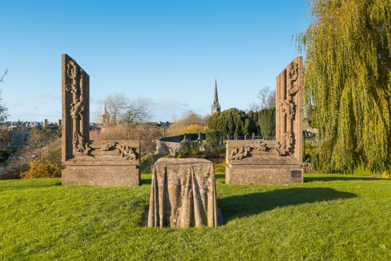 A partially built large stone picture frame with a stone table in the middle