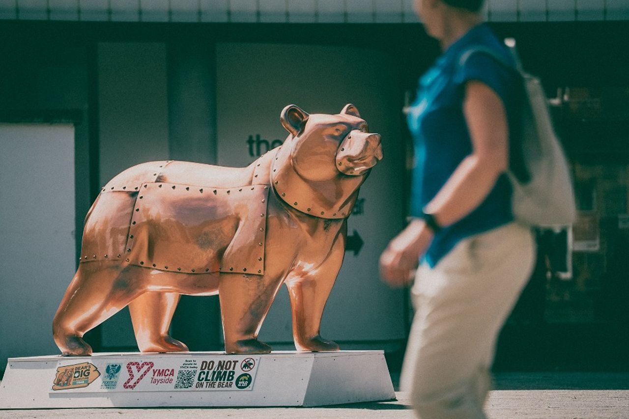 A cermaic bear painted to look like it is made of copper to represent the industrialisation.