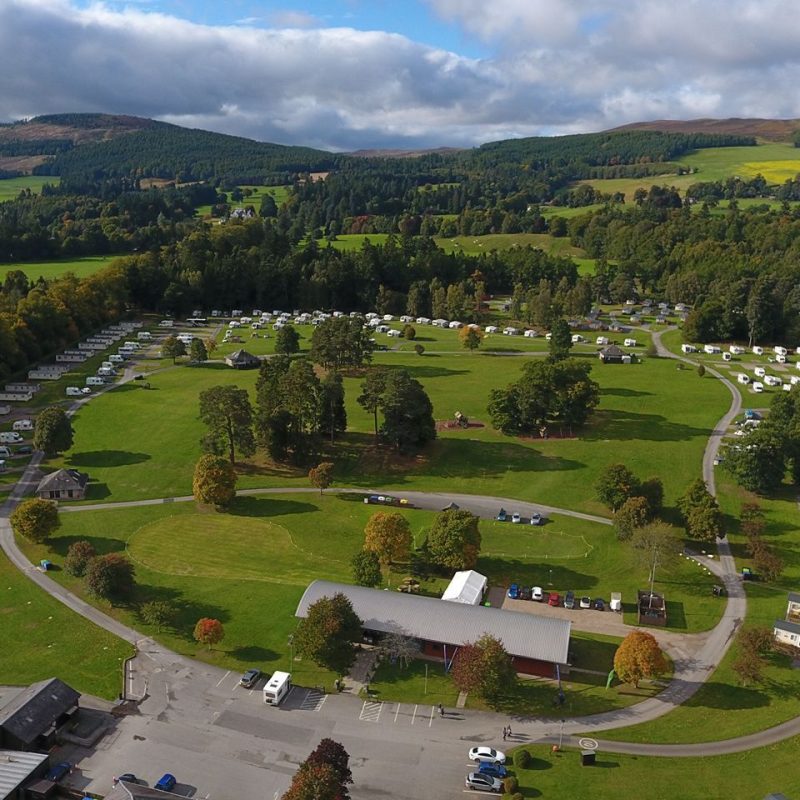 Ariel view of a circular road with caravans on plots with hills in the distance