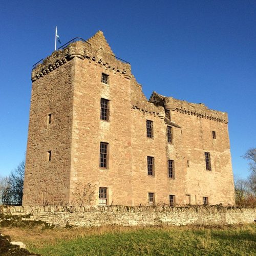 Blue, sunny day with old large stone castle.