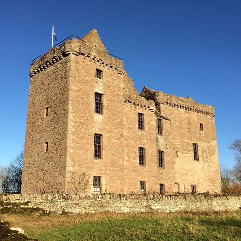 Blue, sunny day with old large stone castle.