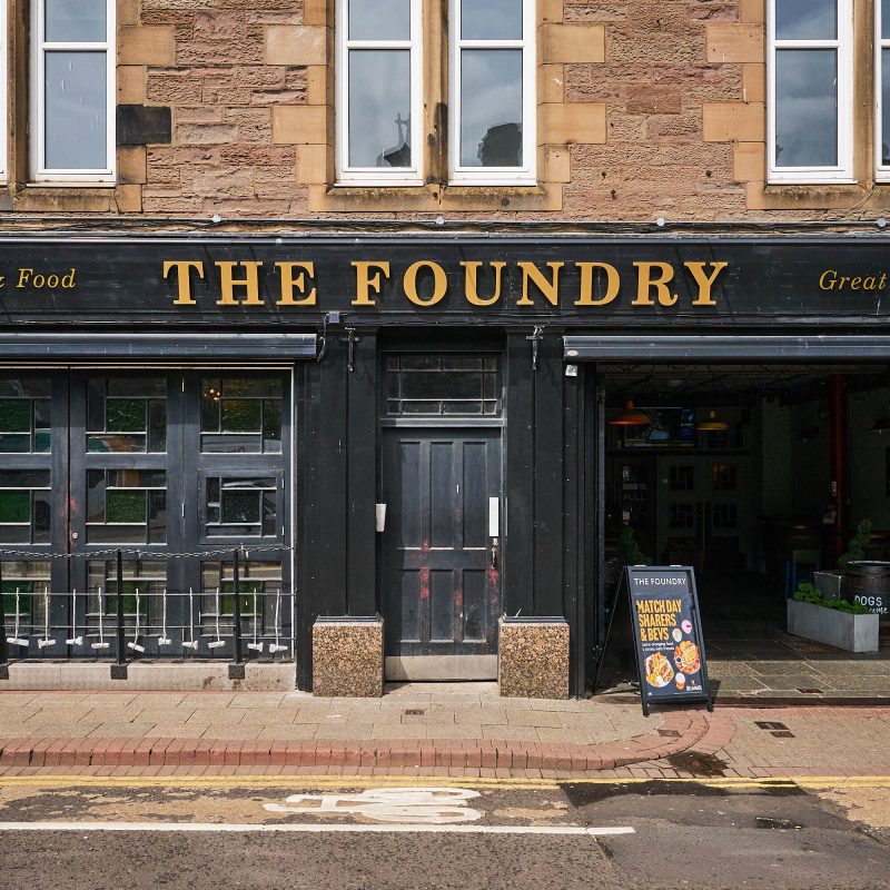 A black building with gold text which says 'The Foundry'