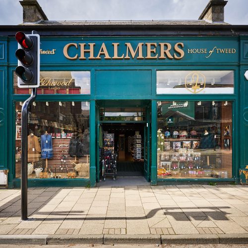 A dark green storefront with a gold sign which reads Chalmers.