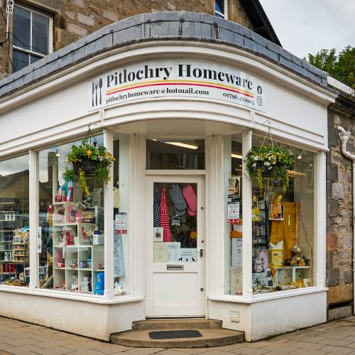 A white building with a white sign which reads 'Pitlochry Homeware.'