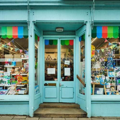A light blue shop wiht green and red accents.