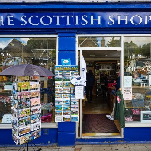 A navy store shop with postcard stands outside.