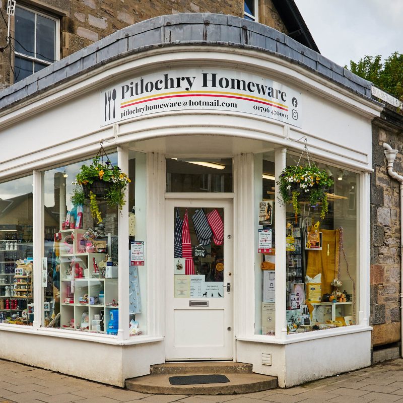 A white building with a white sign which reads 'Pitlochry Homeware.'