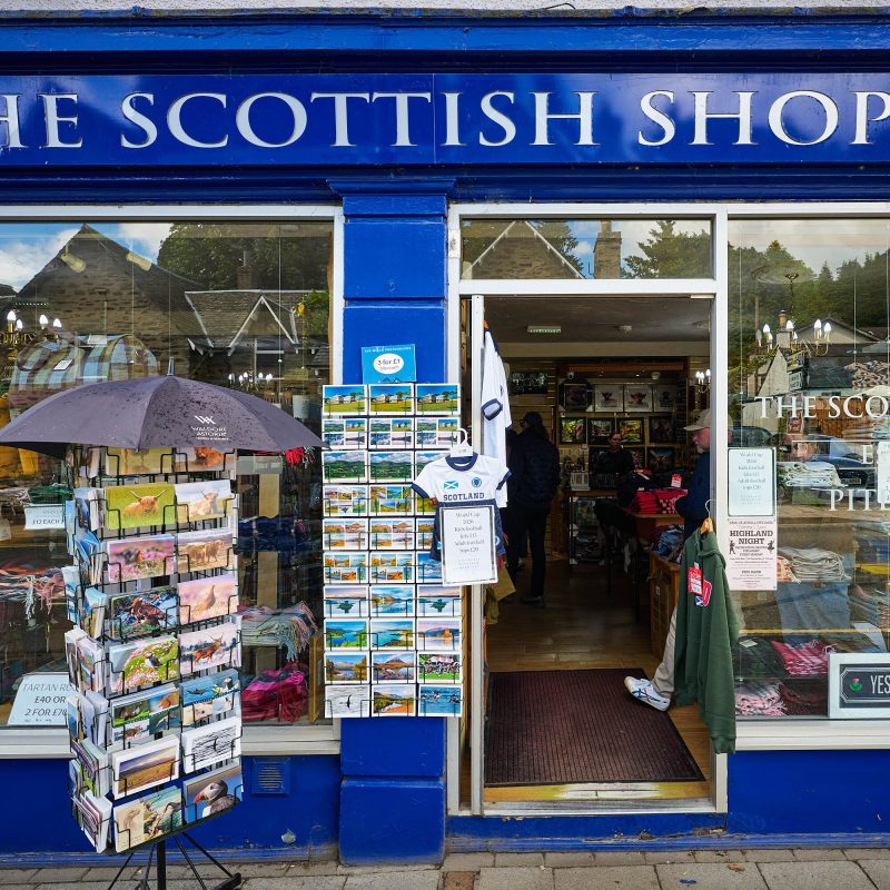 A navy store shop with postcard stands outside.