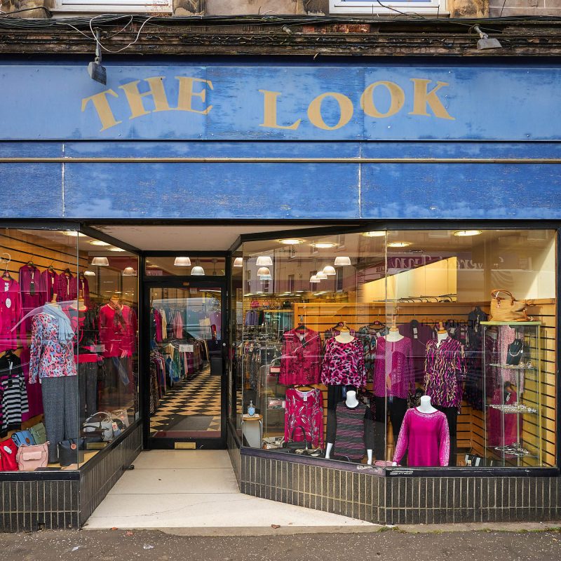 Large glass fronted shop with bright pink clothing items displayed, shop sign says The Look