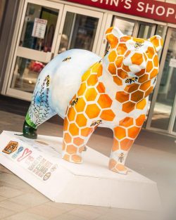 painted bear sculpture with honeycomb decor