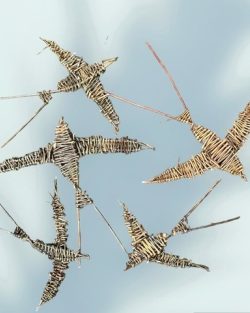 A collection of handmade birds which are woven
