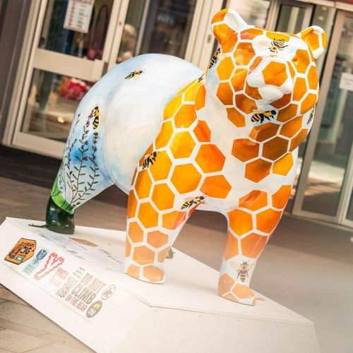 painted bear sculpture with honeycomb decor