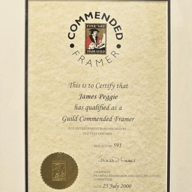 A framed beige certificate issuing a farming qualification to James Peggie, written in cursive and finished with a gold seal